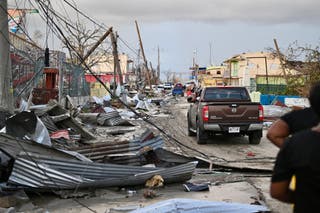 Hurricane Melissa live updates: At least 34 dead as ‘catastrophic’ storm continues to wreak havoc in Bahamas A car drives through the a destroyed neighborood following the passage of Hurricane Melissa, in Black River, Jamaica